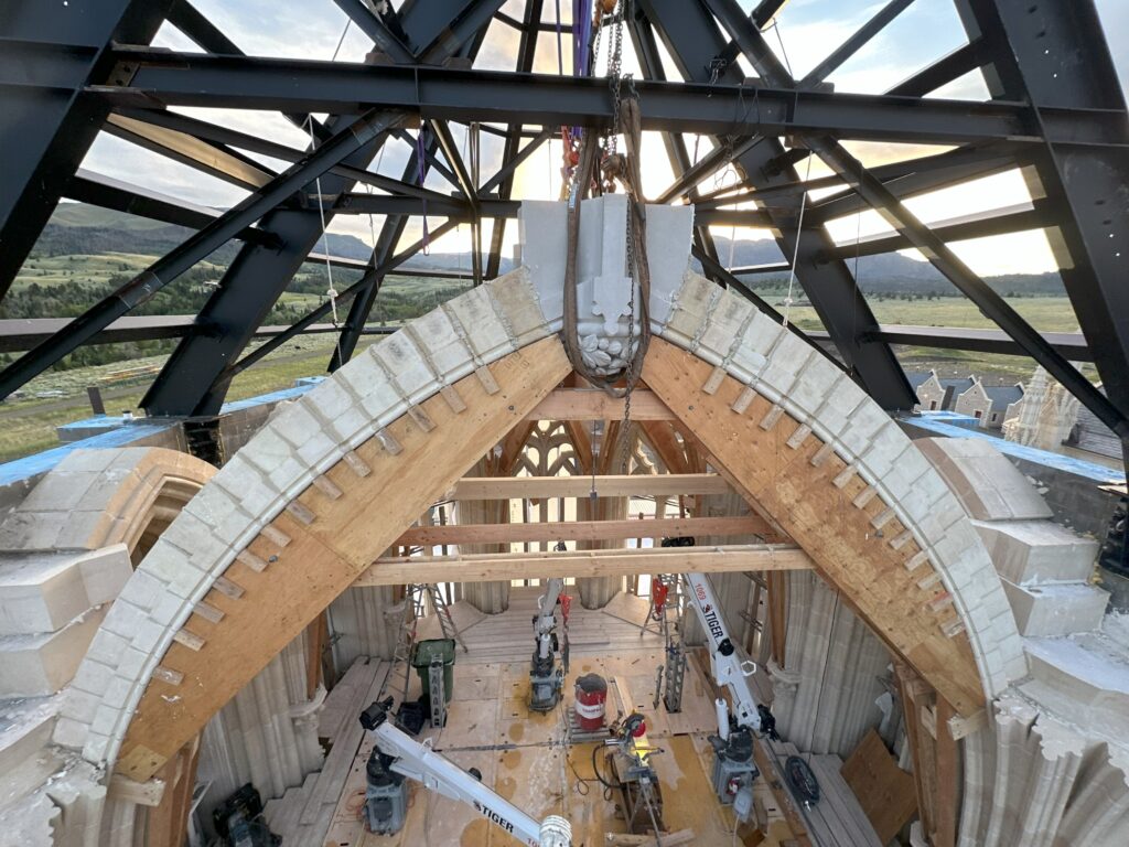 The keystone is suspended and then the arches built up to meet it.